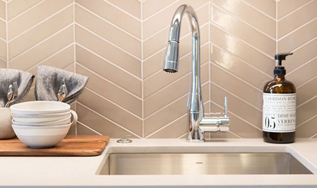 Spacious and well lit kitchen with wood floors and stainless steel appliances